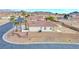 Single-story house with two-car garage and desert landscaping at 53 Flowering Desert Dr, Palm Gardens, NV 89039