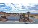 Single-story house with two-car garage and desert landscaping at 53 Flowering Desert Dr, Palm Gardens, NV 89039