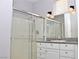 Bathroom with granite countertop, shower, and white vanity at 53 Flowering Desert Dr, Palm Gardens, NV 89039
