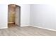 Primary bedroom with wood-look floors and ensuite access at 53 Flowering Desert Dr, Palm Gardens, NV 89039