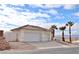 Two-car garage, desert landscaping, and a two-story home with a tile roof at 53 Flowering Desert Dr, Palm Gardens, NV 89039