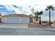 Two-car garage and desert landscaping at 53 Flowering Desert Dr, Palm Gardens, NV 89039