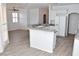 Island kitchen with granite countertops and white cabinets at 53 Flowering Desert Dr, Palm Gardens, NV 89039