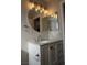 Vanity with marble countertop, round mirror, and light fixture at 5524 Big Sky Ln, Las Vegas, NV 89149