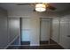 Bright bedroom with mirrored closet doors, a modern ceiling fan, and ample natural light, offering a cozy retreat at 5524 Big Sky Ln, Las Vegas, NV 89149