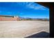 Open backyard landscape featuring snow capped mountains and wide open spaces on a sunny day at 5841 Genoa Ave, Pahrump, NV 89060