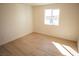 Bedroom with a window that provides natural light and wood-look flooring at 5841 Genoa Ave, Pahrump, NV 89060