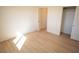 Bedroom with wood-look flooring, a view into an adjacent room and a closet with double doors at 5841 Genoa Ave, Pahrump, NV 89060