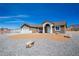 Beautiful single-story home with desert landscaping, a two-car garage and bright entry way at 5841 Genoa Ave, Pahrump, NV 89060