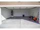 Spacious two car garage featuring concrete floors, an insulated door, and an included water heater at 5841 Genoa Ave, Pahrump, NV 89060