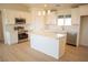 Bright kitchen featuring white cabinets, stainless steel appliances, an island, and plenty of counter space at 5841 Genoa Ave, Pahrump, NV 89060