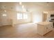 Bright open-concept living space featuring hardwood floors and an adjacent kitchen at 5841 Genoa Ave, Pahrump, NV 89060