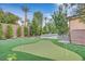 Spacious backyard oasis with putting green and mature trees at 65 Garibaldi Way, Henderson, NV 89011