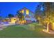 Landscaped backyard with putting green and night lighting at 65 Garibaldi Way, Henderson, NV 89011