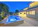 Luxury home with a stunning pool and spa at dusk at 65 Garibaldi Way, Henderson, NV 89011