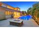 Luxury backyard oasis with a pool, fire pit, and ample space at 65 Garibaldi Way, Henderson, NV 89011