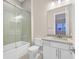 Modern bathroom with a glass shower, white vanity, and neutral tile at 65 Garibaldi Way, Henderson, NV 89011