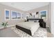 Spacious bedroom with a king-size bed and large windows at 65 Garibaldi Way, Henderson, NV 89011