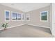Bright bedroom with carpeting, window shutters, and neutral walls at 65 Garibaldi Way, Henderson, NV 89011