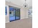 Bright dining room with modern chandelier and sliding glass door leading to backyard at 65 Garibaldi Way, Henderson, NV 89011