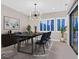 Virtually staged dining room with a large table and access to backyard at 65 Garibaldi Way, Henderson, NV 89011