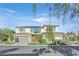 Beautiful two-story home featuring a well-manicured lawn and a three-car garage at 65 Garibaldi Way, Henderson, NV 89011