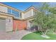 Modern home exterior with a unique gate and landscaping at 65 Garibaldi Way, Henderson, NV 89011