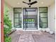 Modern front entrance with glass door, brick flooring, and potted plants at 65 Garibaldi Way, Henderson, NV 89011