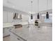 Modern kitchen with white cabinets, stainless steel appliances, and large island at 65 Garibaldi Way, Henderson, NV 89011