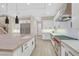 Modern kitchen with white cabinets, stainless steel appliances, and an island at 65 Garibaldi Way, Henderson, NV 89011