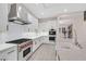 Modern kitchen with white cabinets, stainless steel appliances, and large island at 65 Garibaldi Way, Henderson, NV 89011