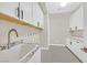 Bright laundry room with ample cabinetry and granite countertops at 65 Garibaldi Way, Henderson, NV 89011