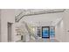 Bright open living space with a wet bar, staircase, and views to the outside at 65 Garibaldi Way, Henderson, NV 89011