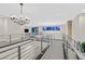 Bright loft with metal railings and a modern chandelier at 65 Garibaldi Way, Henderson, NV 89011