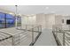 Modern loft hallway with chandelier and metal railings at 65 Garibaldi Way, Henderson, NV 89011