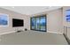 Media room with large TV and access to private balcony at 65 Garibaldi Way, Henderson, NV 89011
