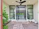 Inviting outdoor patio with stone flooring, seating, and open entryway to the pool at 65 Garibaldi Way, Henderson, NV 89011