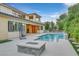 Relaxing pool and spa area with fire pit and seating at 65 Garibaldi Way, Henderson, NV 89011
