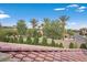 Residential street view with lush landscaping and palm trees at 65 Garibaldi Way, Henderson, NV 89011