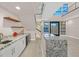 Granite wet bar with wine fridge under the staircase and floating shelves at 65 Garibaldi Way, Henderson, NV 89011