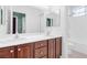 Bathroom featuring double sinks with wood cabinets, creating a functional and well-lit space at 6545 Candleglade Ct, North Las Vegas, NV 89084