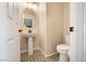 Powder room with pedestal sink and patterned tile floor at 7044 Stockton Dunes St, North Las Vegas, NV 89084