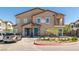 Tan two-story townhome with teal door and landscaping at 7230 N Decatur Blvd # 6, Las Vegas, NV 89131