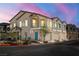 Two-story townhome at dusk with attached garages at 7230 N Decatur Blvd # 6, Las Vegas, NV 89131