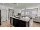 Open concept kitchen with island, stainless steel appliances, and dark cabinetry at 7230 N Decatur Blvd # 6, Las Vegas, NV 89131