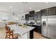 Open concept kitchen with island, stainless steel appliances, and dark cabinetry at 7230 N Decatur Blvd # 6, Las Vegas, NV 89131
