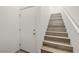 Modern staircase with wood-look treads and white walls at 7230 N Decatur Blvd # 6, Las Vegas, NV 89131