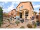 Charming backyard featuring desert landscaping, brick patio under pergola, and a view of the home's rear exterior at 7481 Benlomond Ave, Las Vegas, NV 89179