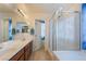 Bathroom features a double sink vanity, glass enclosed shower, and private water closet at 7481 Benlomond Ave, Las Vegas, NV 89179