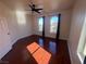 Bright bedroom featuring laminate floors, natural light and arched windows with dark curtains at 7481 Benlomond Ave, Las Vegas, NV 89179